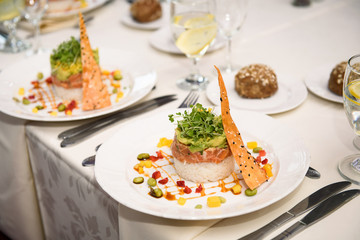 Round plate with salad stands on white table