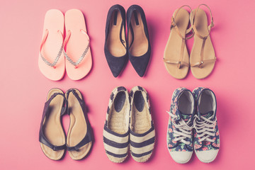 Collection of women's shoes on pink background