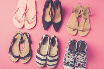 Collection of women's shoes on pink background
