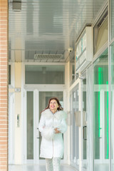 woman walking near shop windows