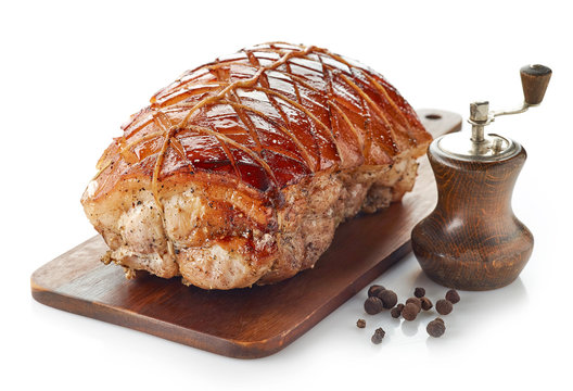 roasted pork on wooden cutting board