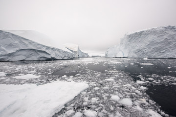 Glaciers On Frozen Ocean Against Sky in Greenland