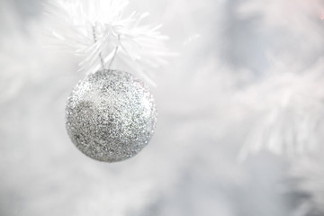 silver glitter ball hang on white christmas tree