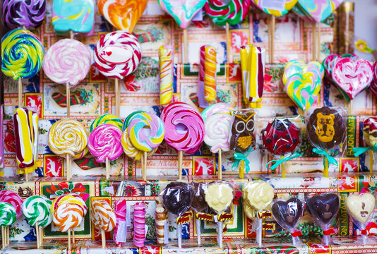 Great Choice Of Colorful Caramel On Stick And Chocolate Candy For Sale In Shop Window