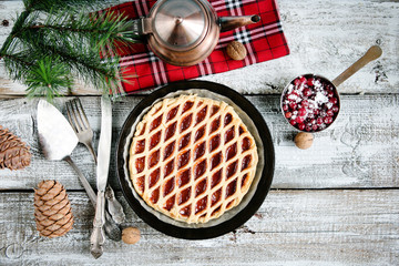 Christmas home sweet cake with jam on a wooden table with a festive serving