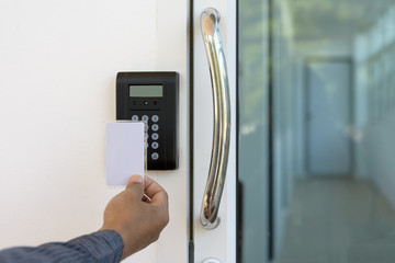 Close-up hand inserting keycard to lock and unlock door - Door a