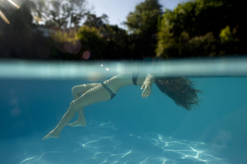 Girl in bikini floating in pool
