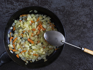 Stewed carrot and onion on pan