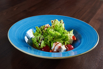 Delicious shrimp salad served on a blue plate
