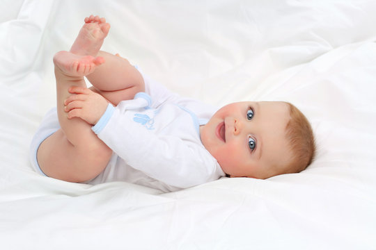 Baby in white bedding.
