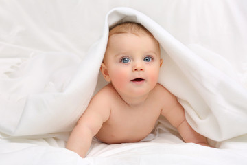 Baby in white bedding.