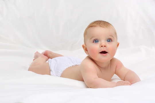 Baby in white bedding.