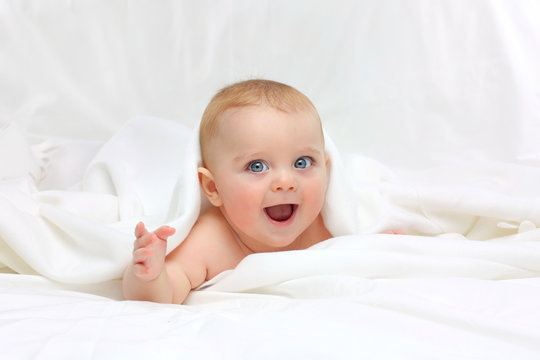 Baby in white bedding.