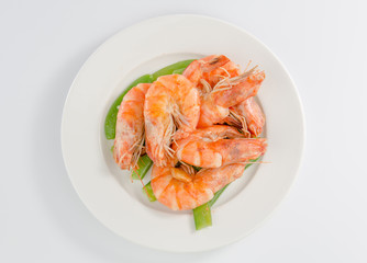 Fried shrimp in a plate isolated on white background