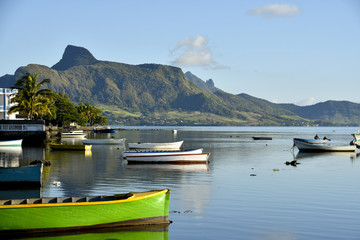 MAHEBOURG, MAURITIUS - View of the fishing landing station with green pirogue - obrazy, fototapety, plakaty