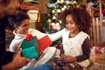 Lovely black child for Christmas with parents