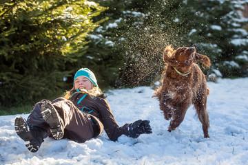 girl in winter scene, Happy teenager  playing with dog  in snow
