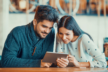 Couple using digital tablet