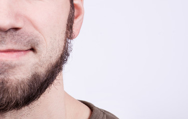 Obraz premium Close-up of young bearded man standing against white background