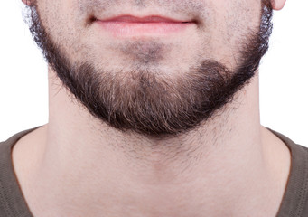 Obraz premium Close-up of young bearded man standing against white background