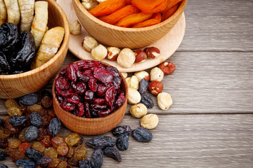 Dried fruits in wooden bowls, tasty health breakfast.