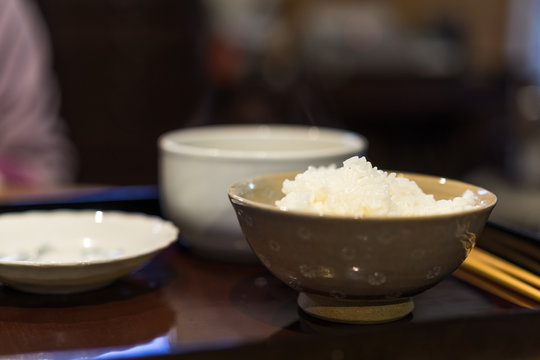 Rice in bowl at asian dining table
