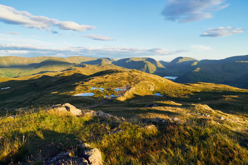 The mountain summit of Place Fell in the Lake District at sunset.