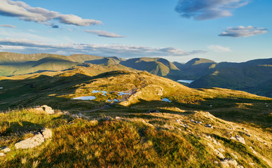 The mountain summit of Place Fell in the Lake District at sunset.