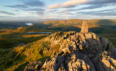 The mountain summit of Place Fell in the Lake District at sunset