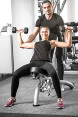 Woman doing fitness with personal trainer help.