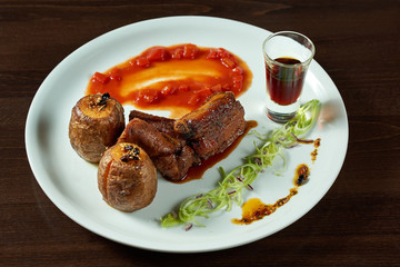 Pork ribs and potatoes on the plate