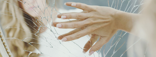 Hand on broken mirror