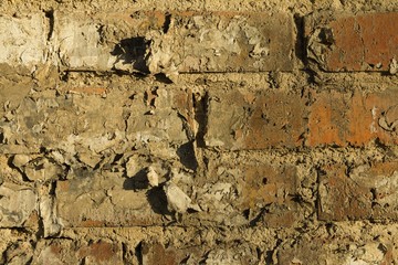 Old brick wall with cracks and scratches. Macro shot.