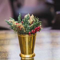 Christmas decoration on a table in a cafe with rowan berries and