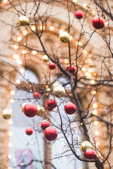Streets fully decorated for Christmas with red and gold balls. C