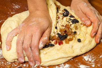 Mixing candied fruit into the dough for Christmas stollen