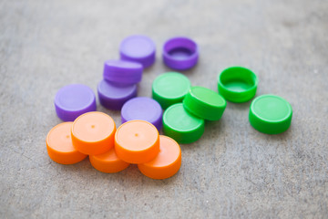 Multicolored bottle caps and plastic bottles