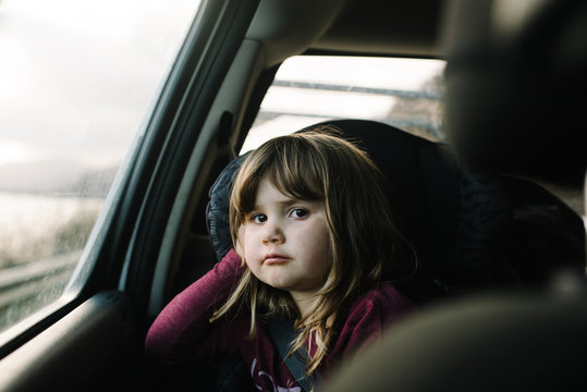 Portrait of girl in car seat