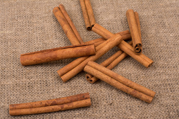 Cinnamon sticks on sackcloth fabric
