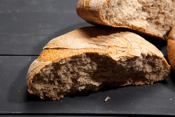 Homemade bread on a black wooden background