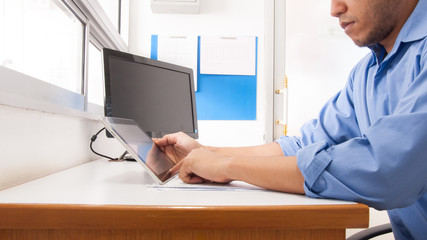 Doctor working at desk in the hospital with his computer.