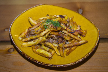 Potatoes fried with pig fat and mushrooms.