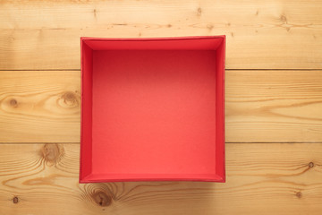 Empty red box on a wooden background