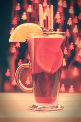 Christmas mulled wine with Christmas trees bokeh background