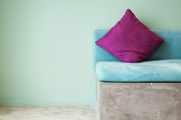 purple pillow on aqua sofa,interior concept