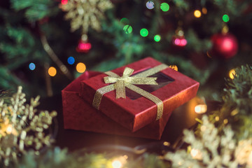 Fototapeta na wymiar New Year's gift under the Christmas tree, Christmas tree ornaments and garland