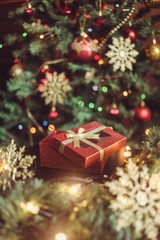 Naklejka na ściany i meble New Year's gift under the Christmas tree, Christmas tree ornaments and garland
