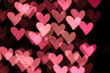 Abstract heart-shaped bokeh background. Abstract defocused background with colorful hearts 