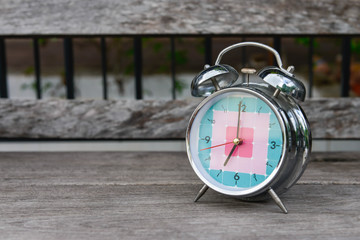 Alarm clock on the wooden table