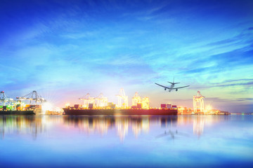 Obraz premium Logistics and transportation of international container cargo ship and cargo plane with ports crane bridge in harbor at sunset sky for logistics import export background and transport industry.